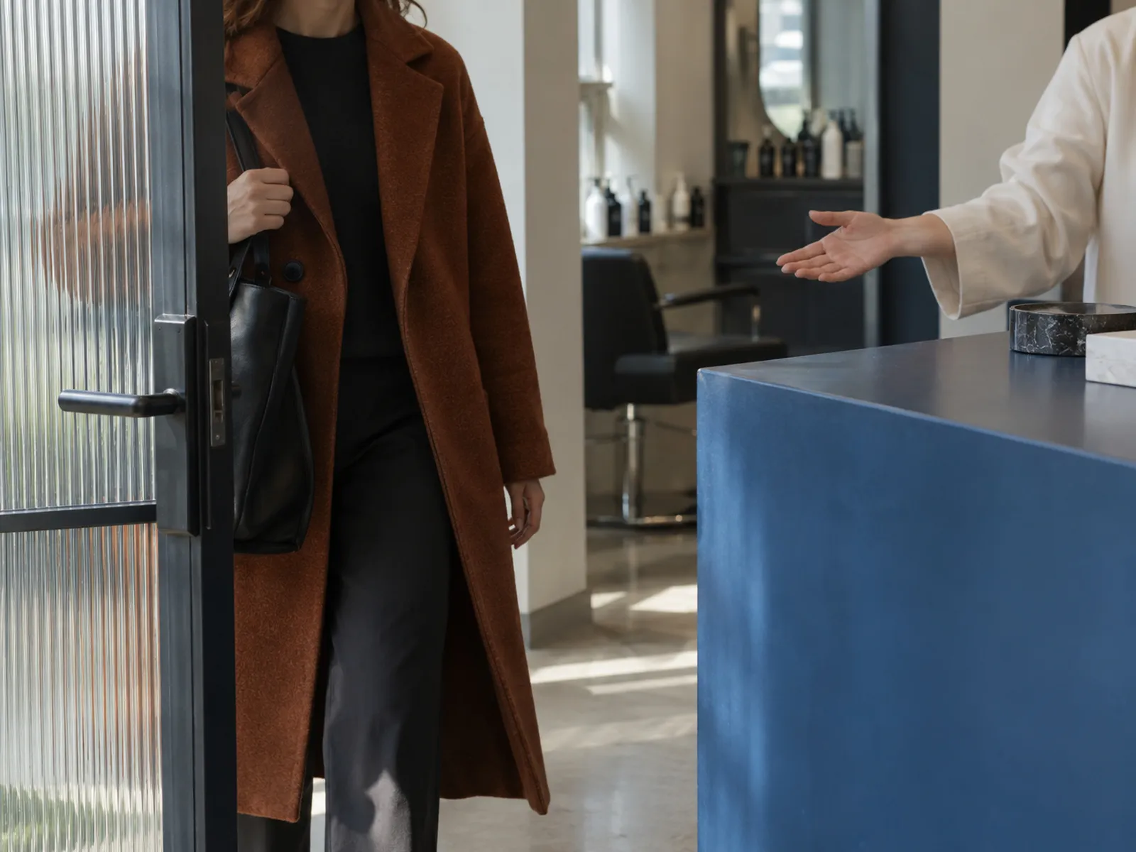 A client arriving at a salon's front desk